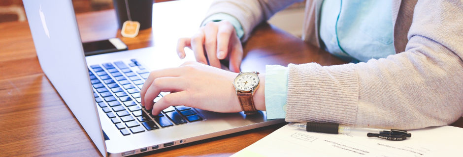 man writing on laptop